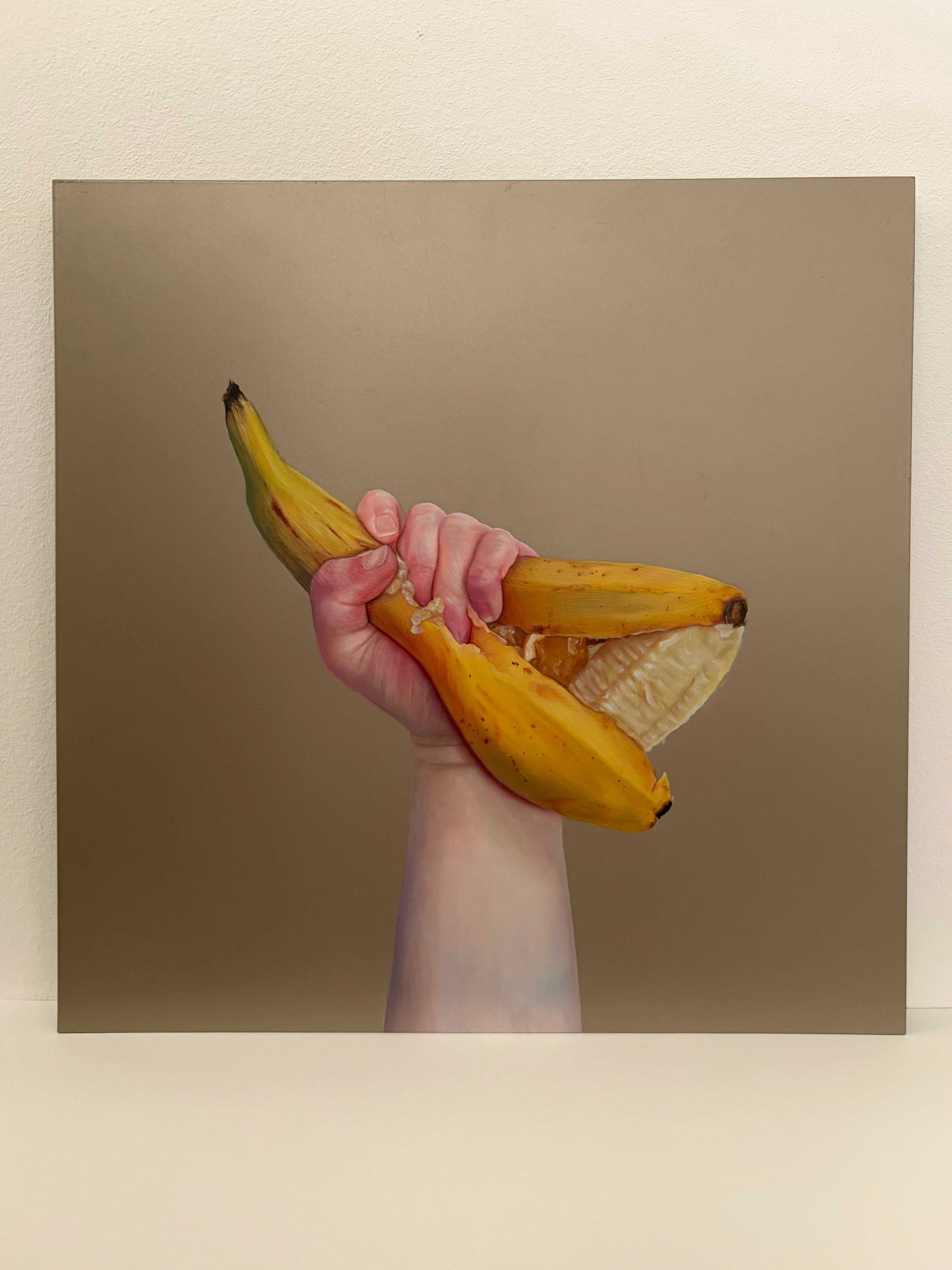 Fine art oil painting of a hand squeezing a banana